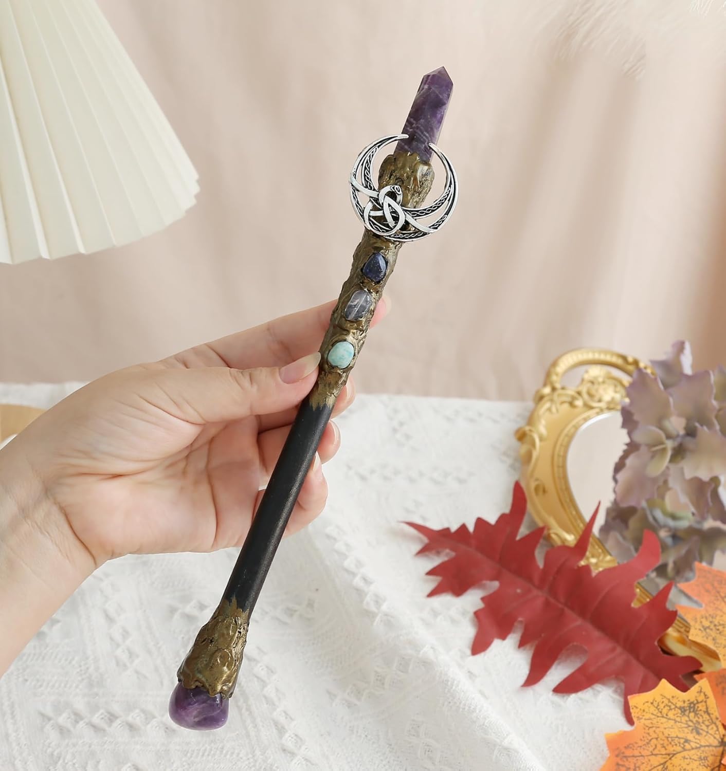 Handcrafted wooden wand, 9 inches, with a clear crystal point at the tip and a small crescent moon charm hanging from the upper shaft.