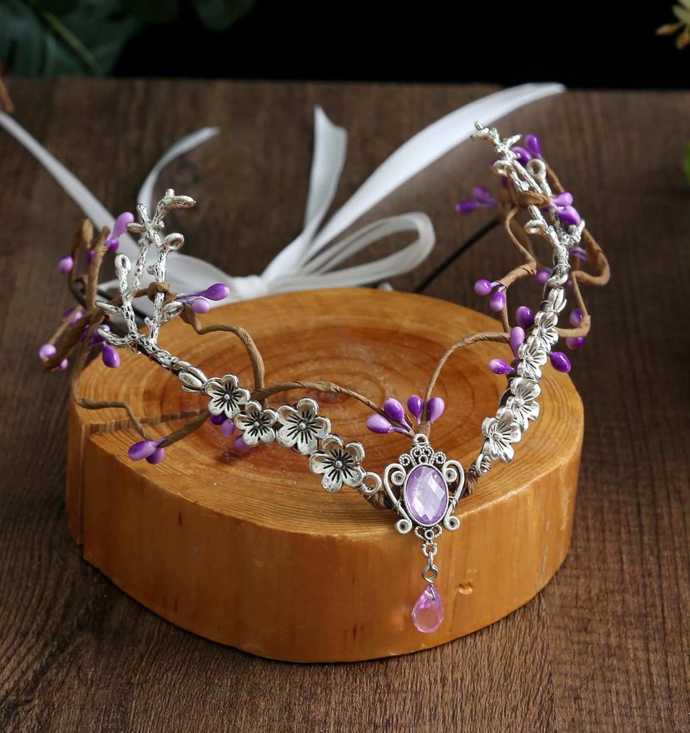 Wire-wrapped flower crown headband with artificial blossoms and leaves, adjustable ribbon tie at the back, fairy and Renaissance style.